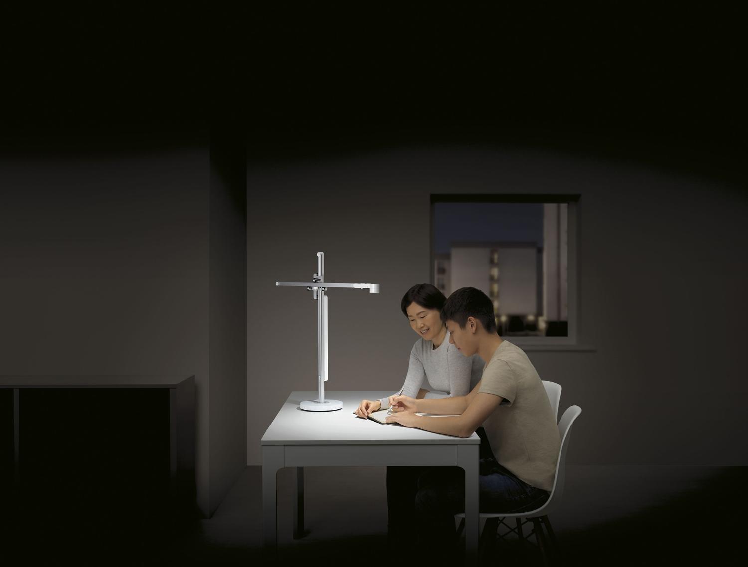Woman and boy working under the light of the Dyson lightcycle