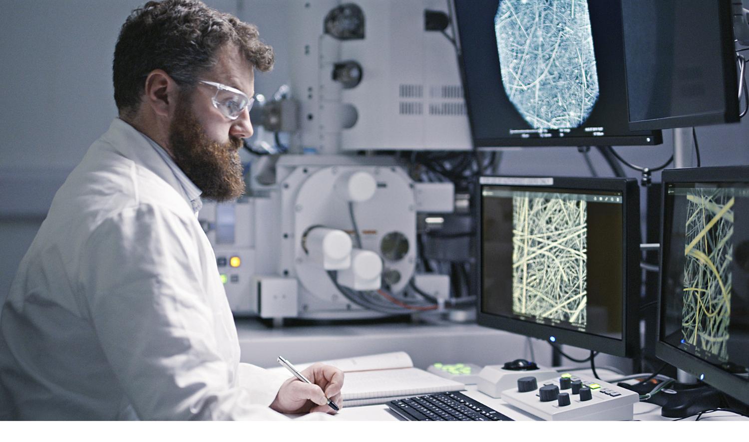 A scientist studying fibres on computer screens