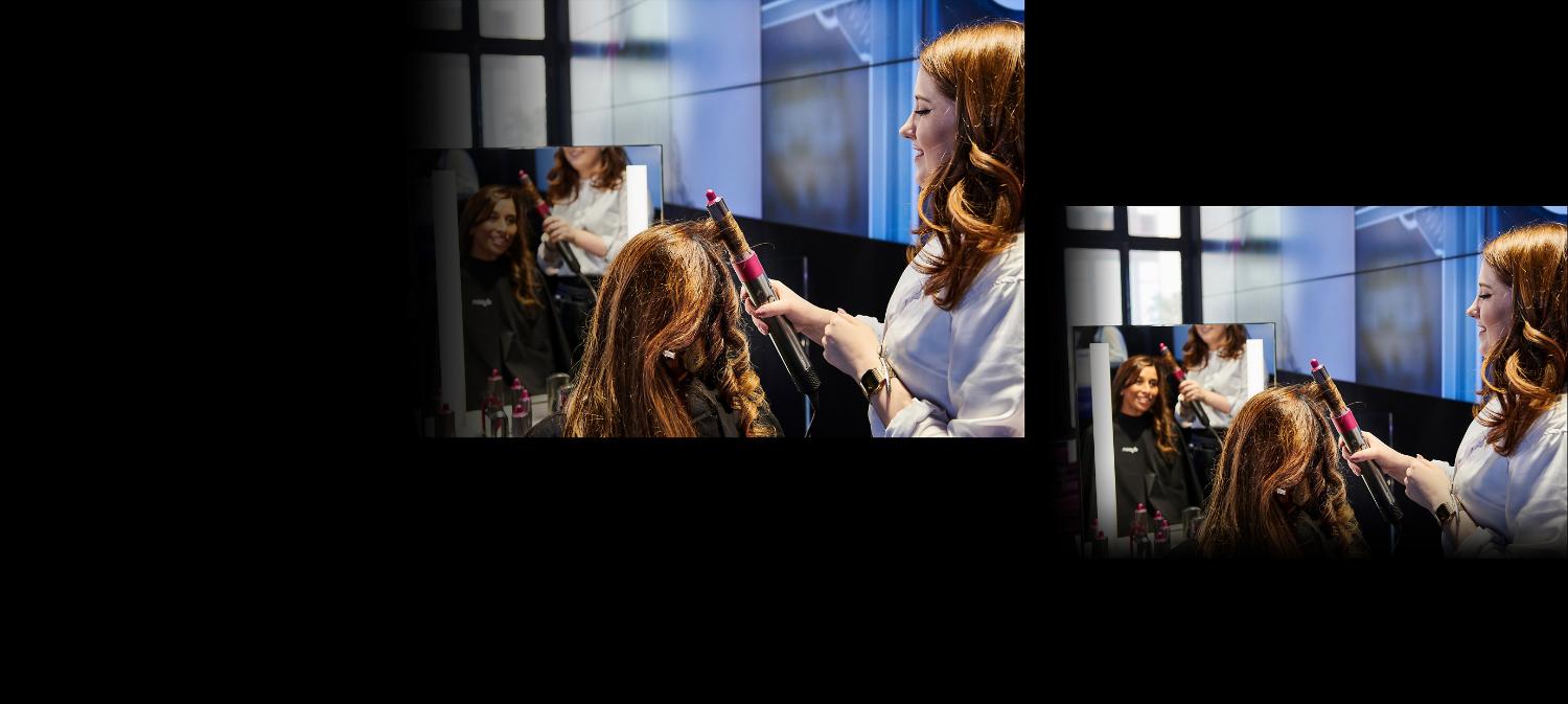 Dyson stylist curling womans hair using the Dyson styler