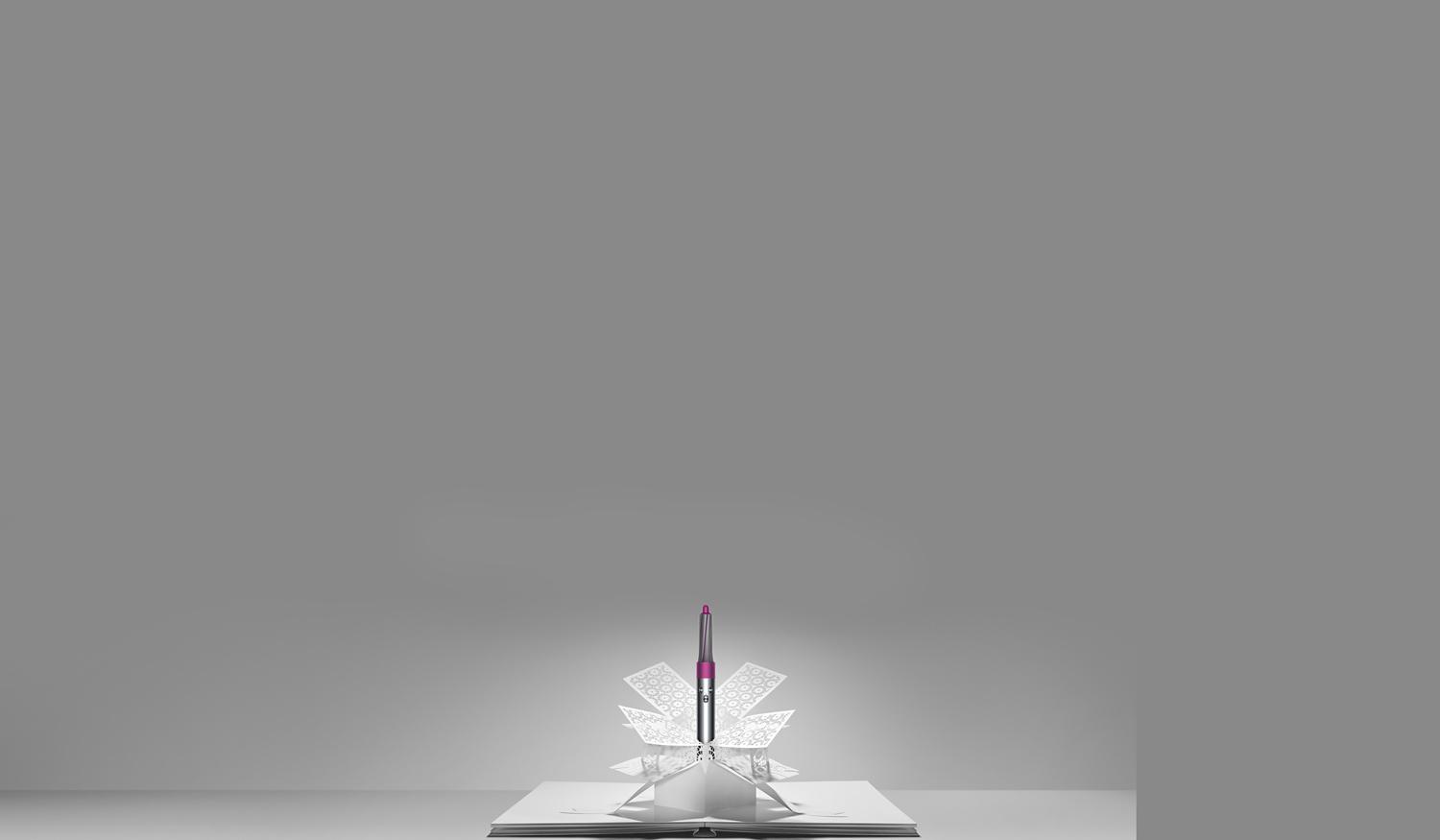 Dyson Airwrap™ styler emerging from paper art