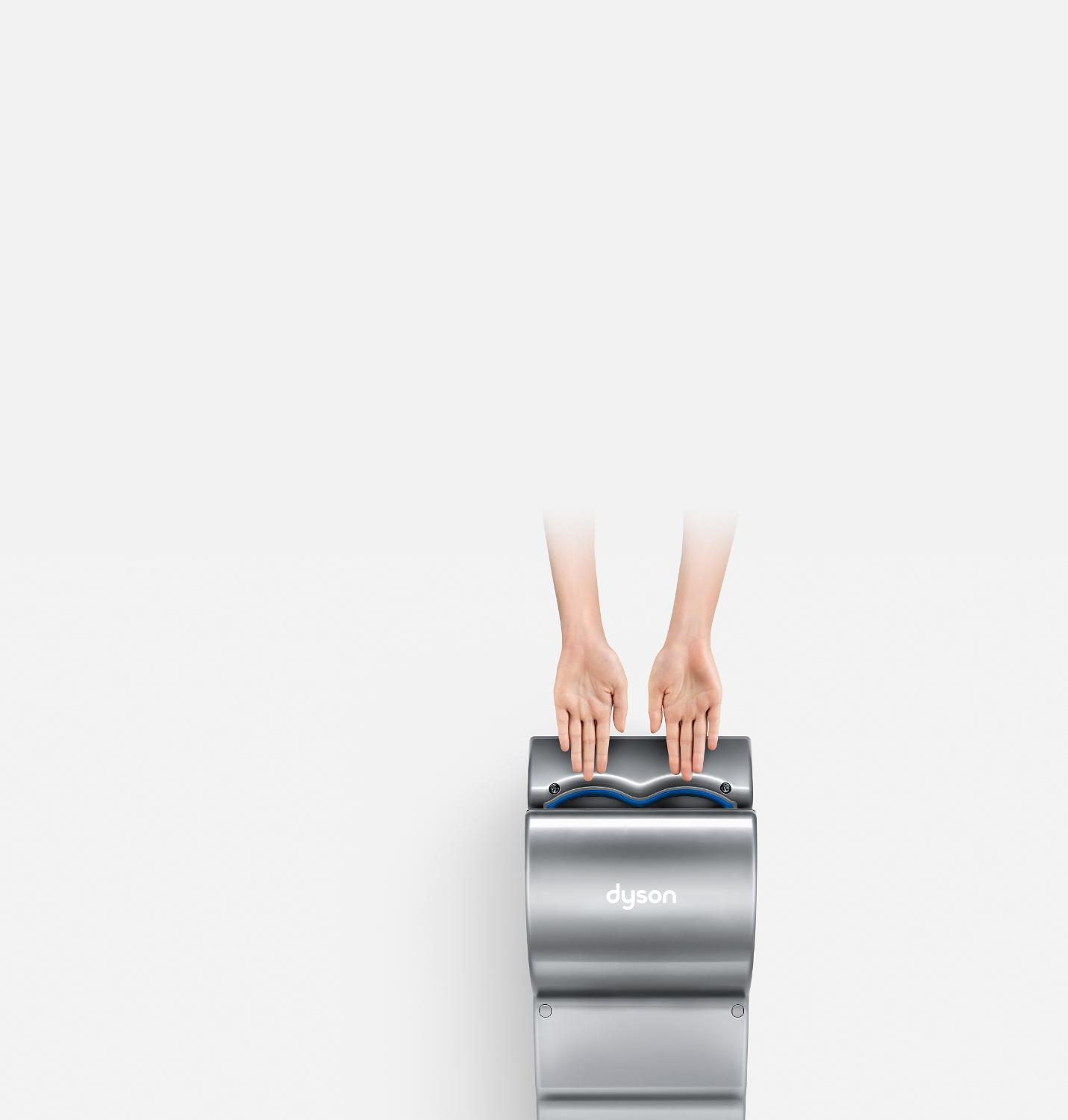 Hands above Dyson hand dryer