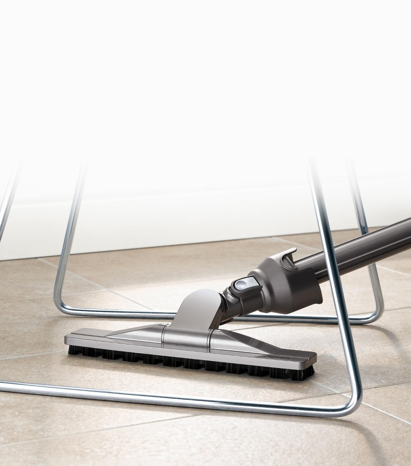 Close up of the articulating hard floor tool reaching in awkward space.