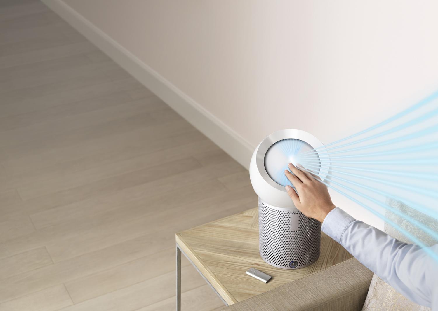 Hand reaching out to refocus airflow with Dyson Core Flow technology