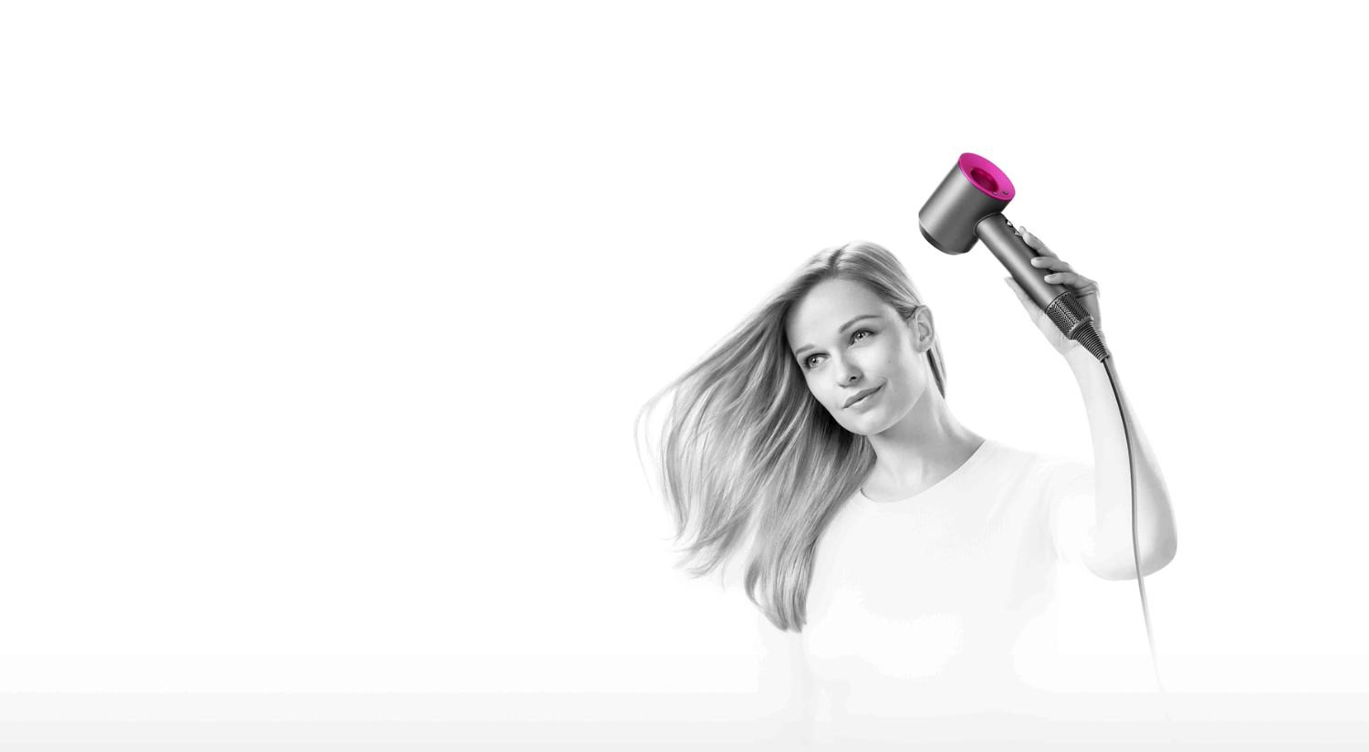 Model with wavy using the Dyson Supersonic hair dryer iron fuchsia