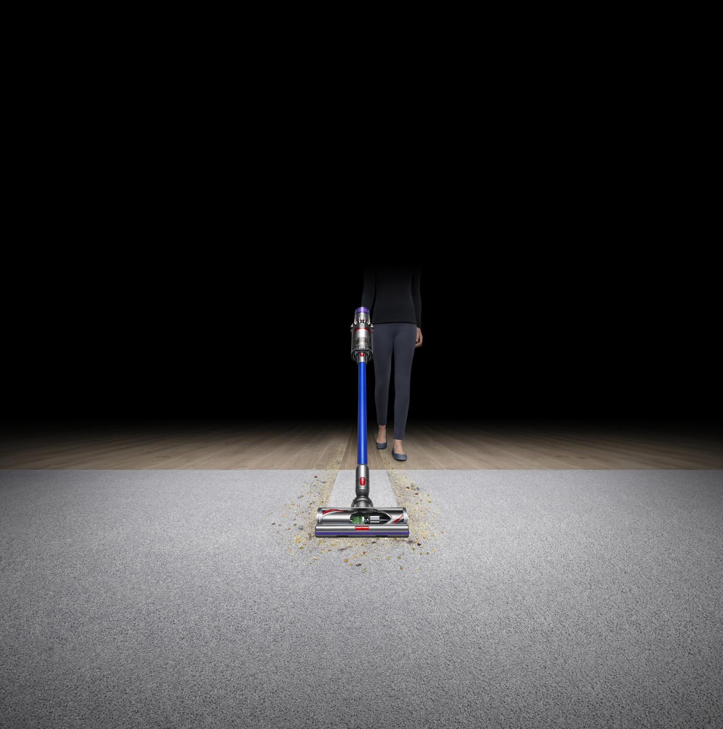 Woman with Dyson V11 vacuum cleaning carpet