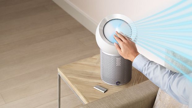 The airstream from a Dyson Pure Cool Me personal purifying fan being adjusted by a hand