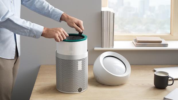 A user changing the filters on the Dyson Pure Cool Me personal purifier fan