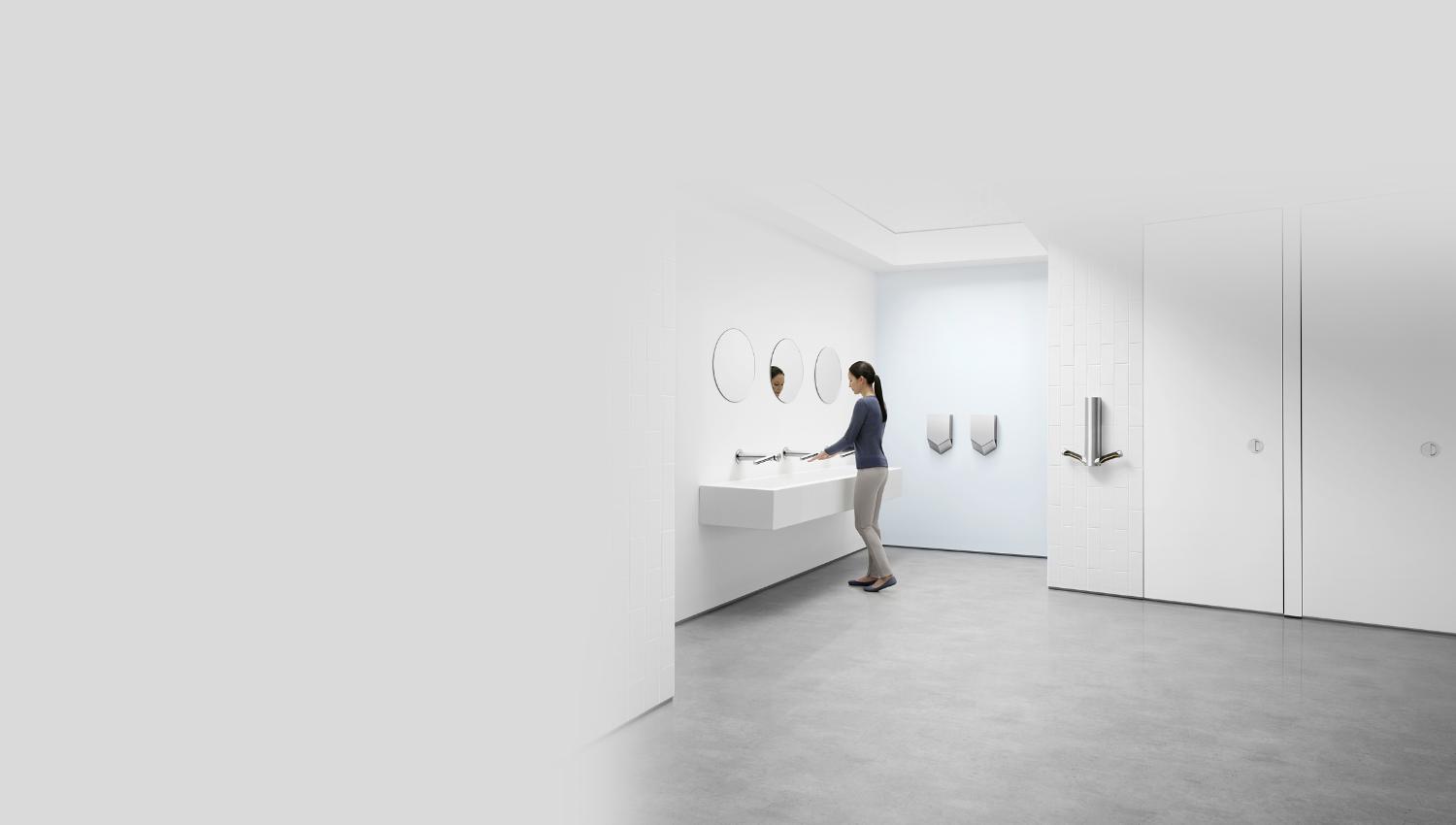 Model using Dyson hand dryers in bathroom