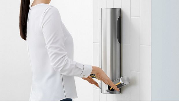 Woman drying hands at Dyson Airblade 9kJ