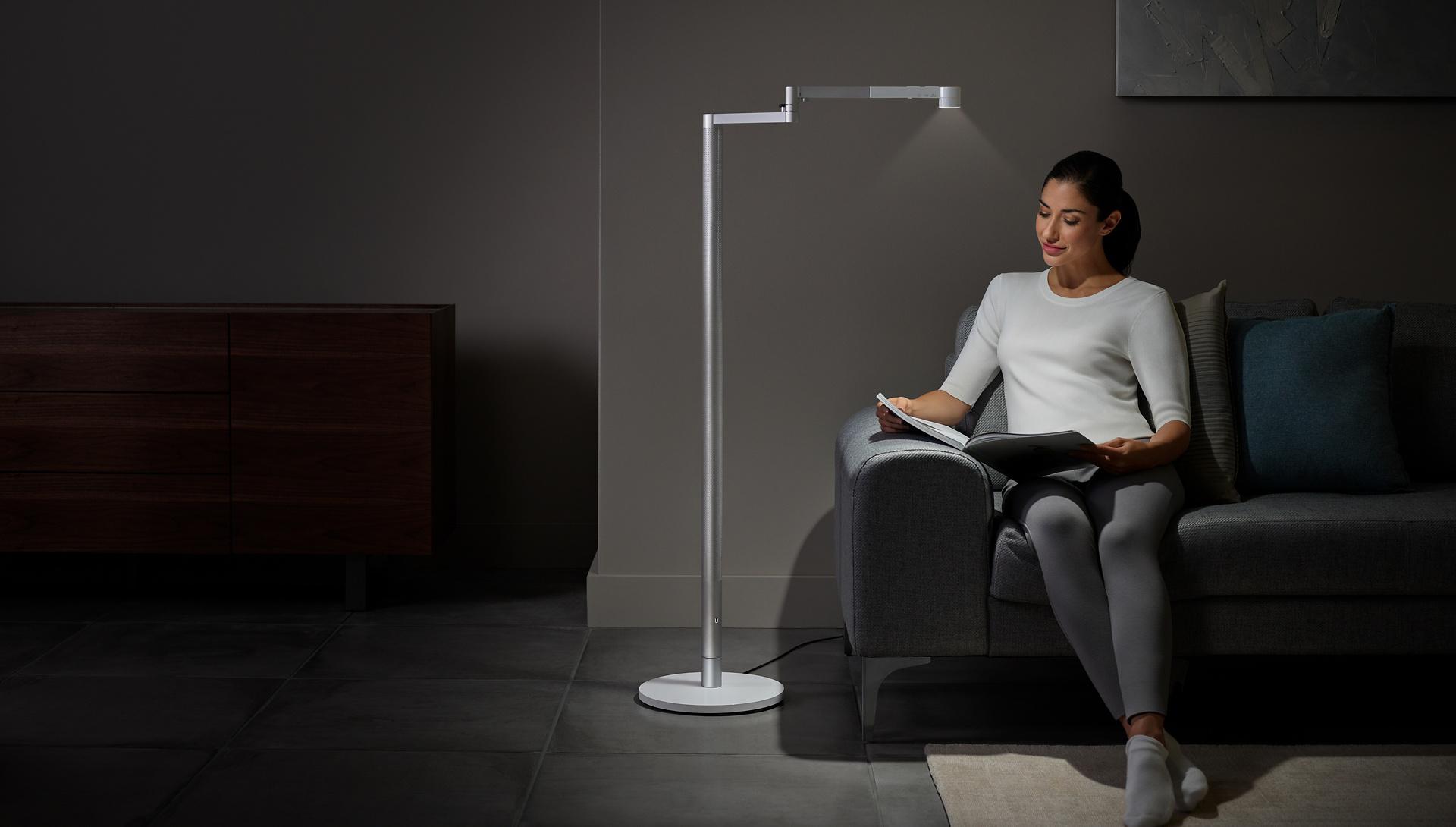 Woman reading under Dyson Lightcycle Morph floor light