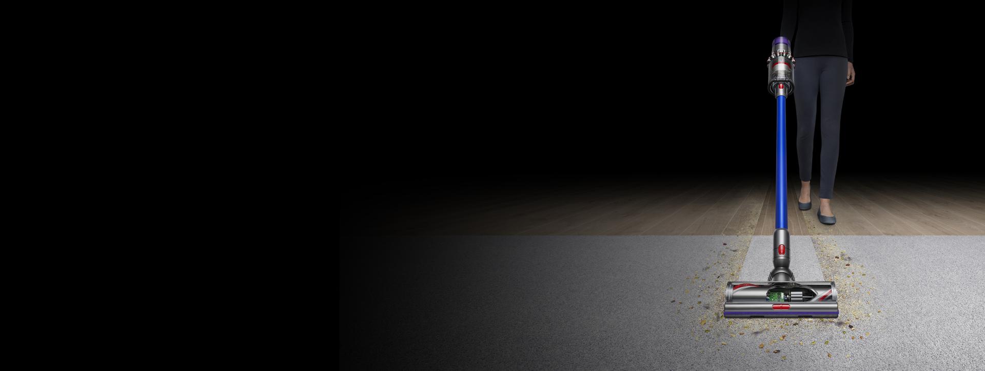 Dyson V11 vacuum picking up dirt from a carpet