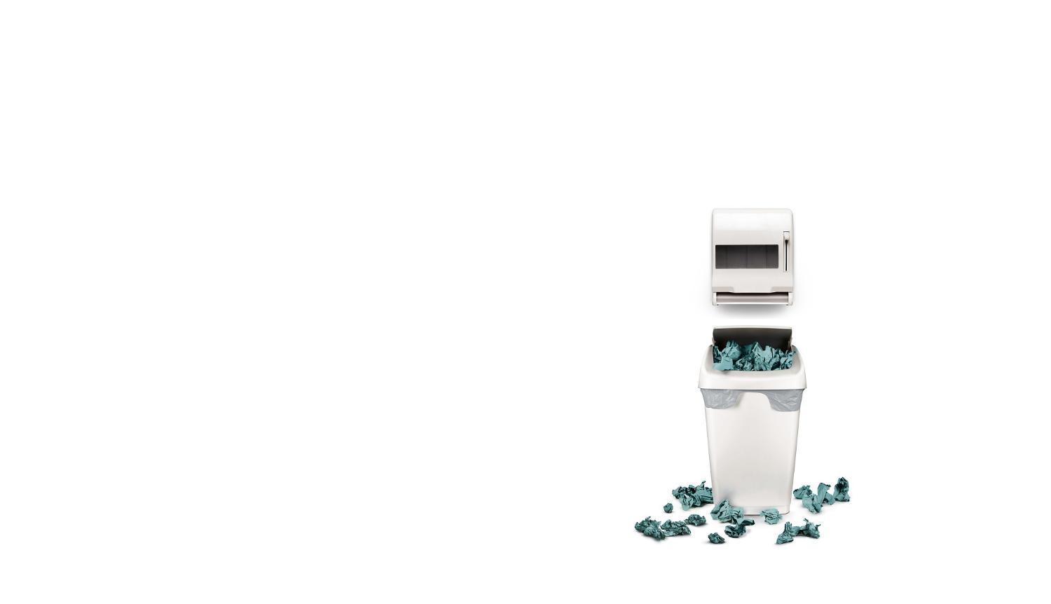 Hand towel dispenser and towels in bin