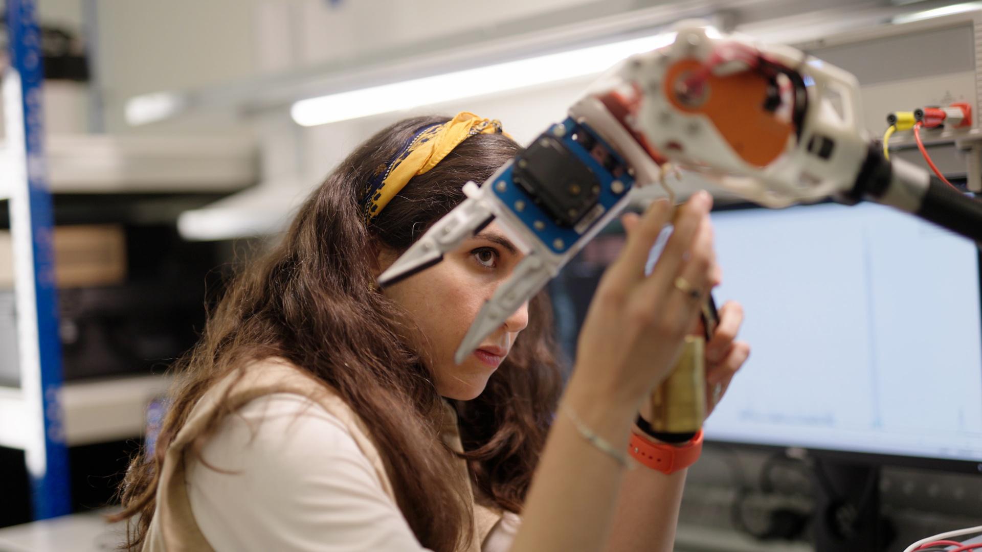Female Engineer with Robotic Arm