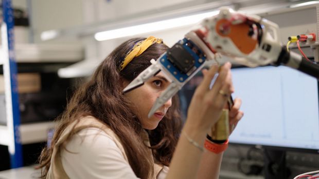 Female Engineer with Robotic Arm