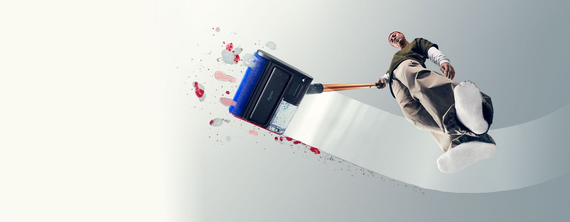 A person effortlessly cleans with the Dyson PencilWash hard floor cleaner.