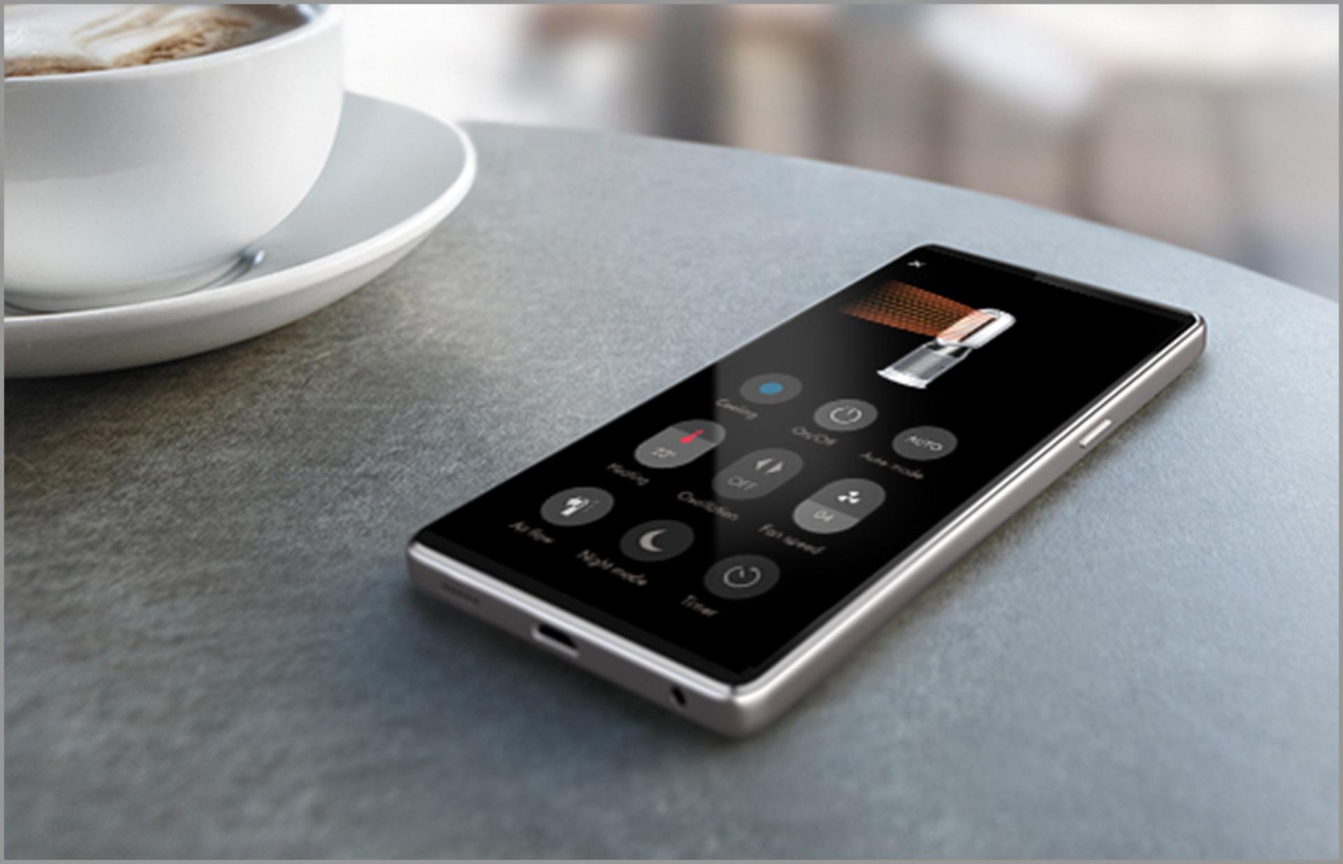 Mobilni telefon na stolu s prikazom aplikacije Dyson Link