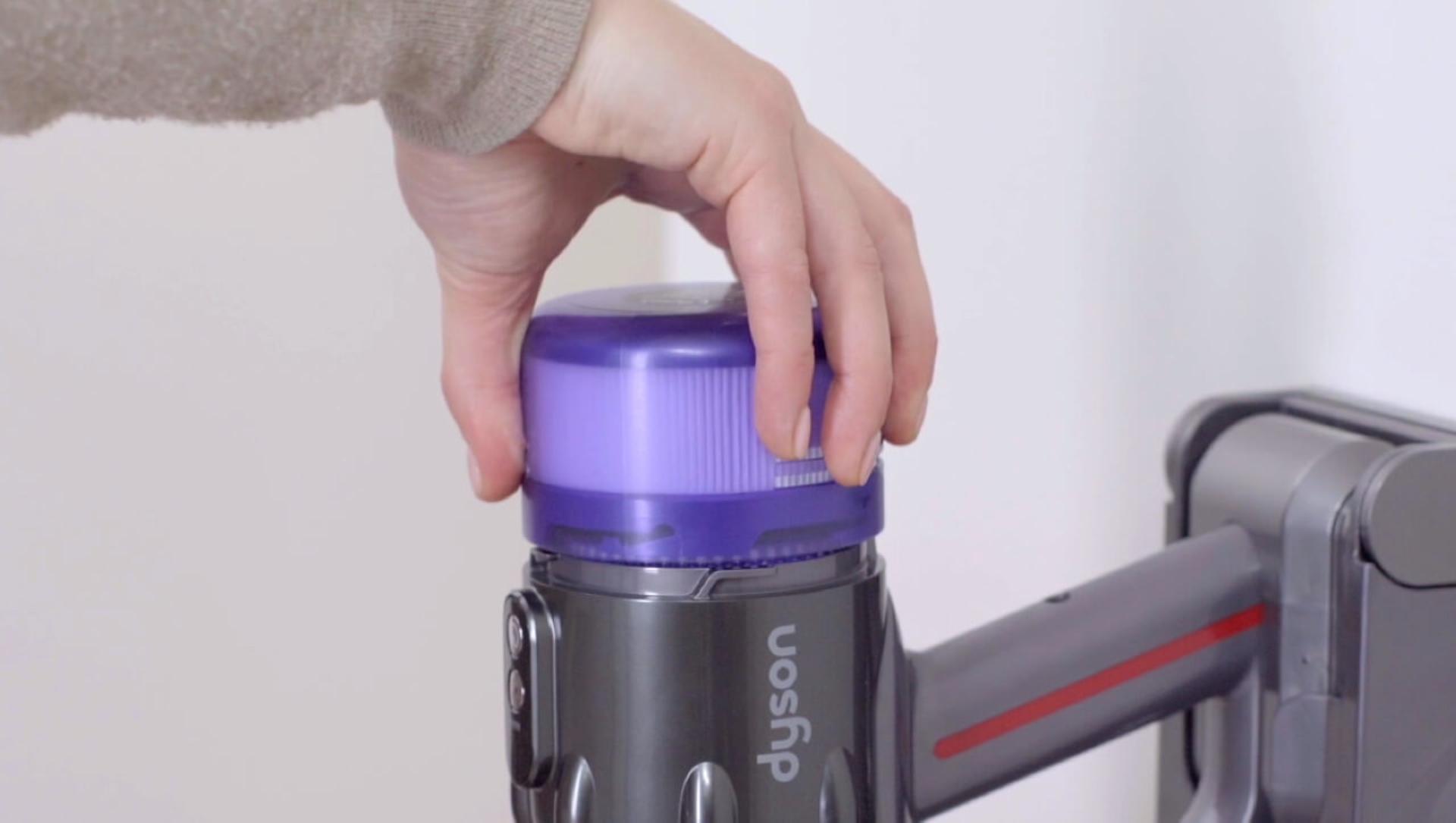 Filter being removed from vacuum.