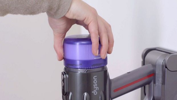 Filter being removed from vacuum.