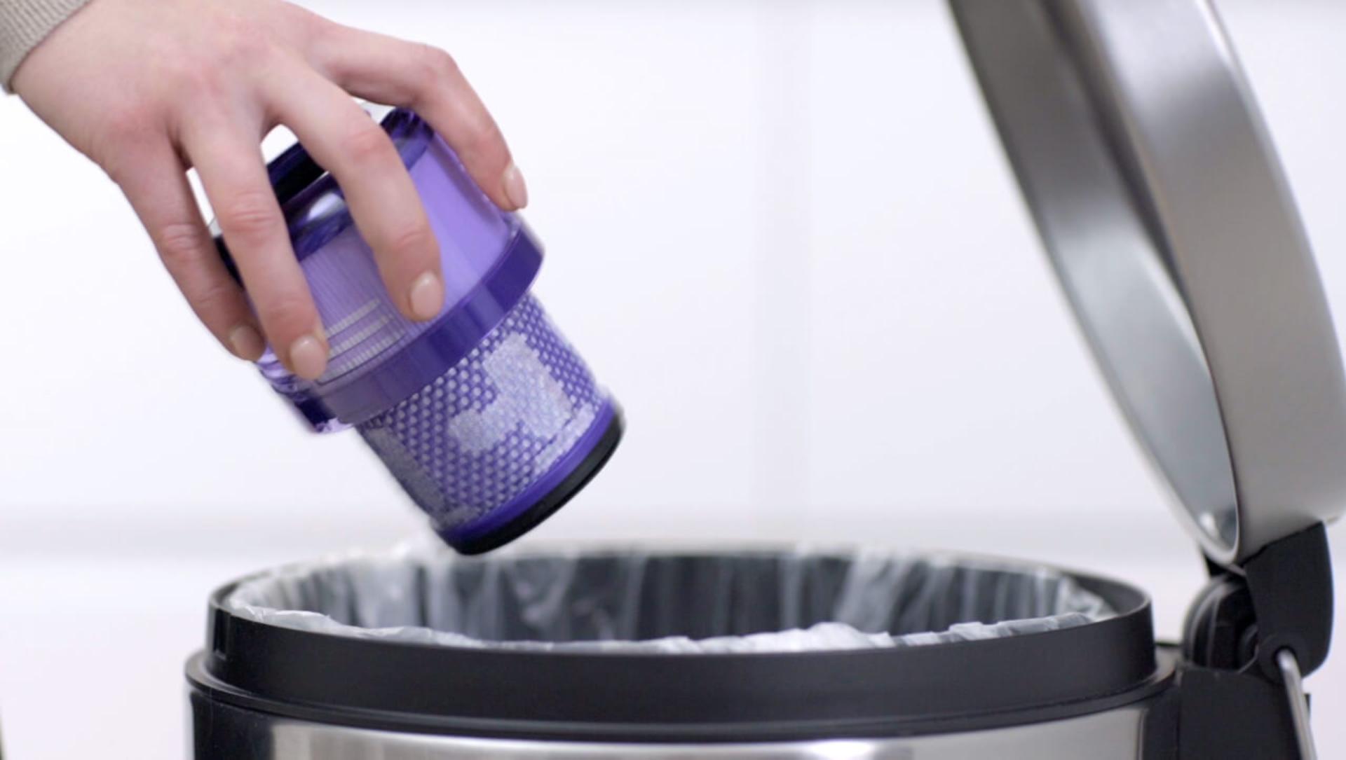 Loose debris being shaken from filter into the bin.