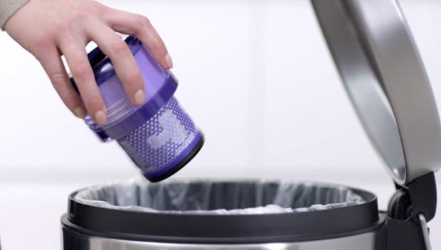 Loose debris being shaken from filter into the bin.