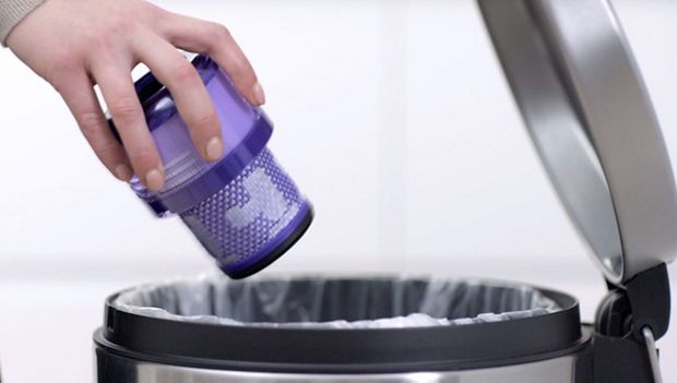 Loose debris being shaken from filter into the bin.