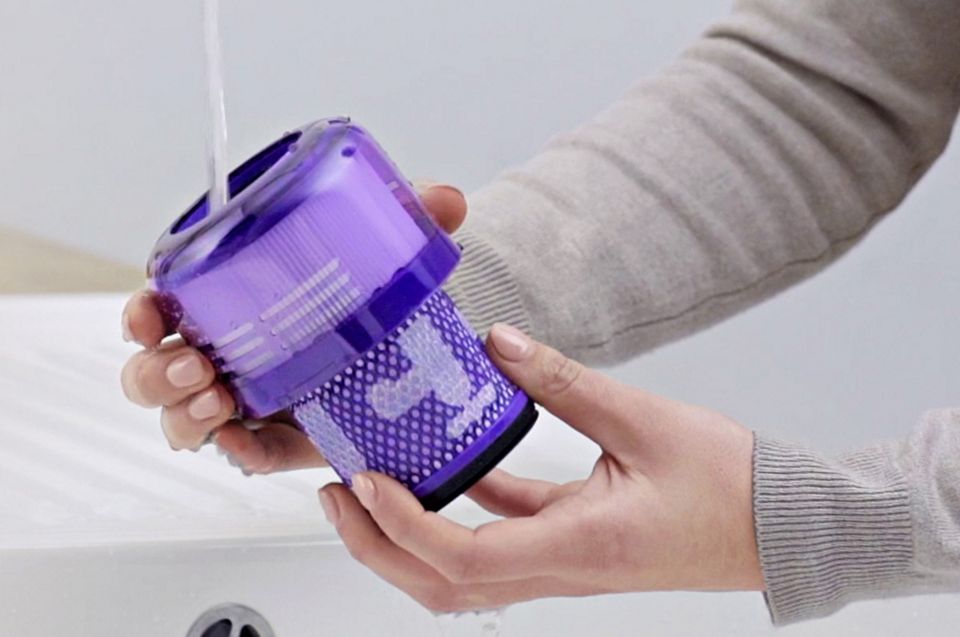 Dyson V12 Origin filter being rinsed under a tap