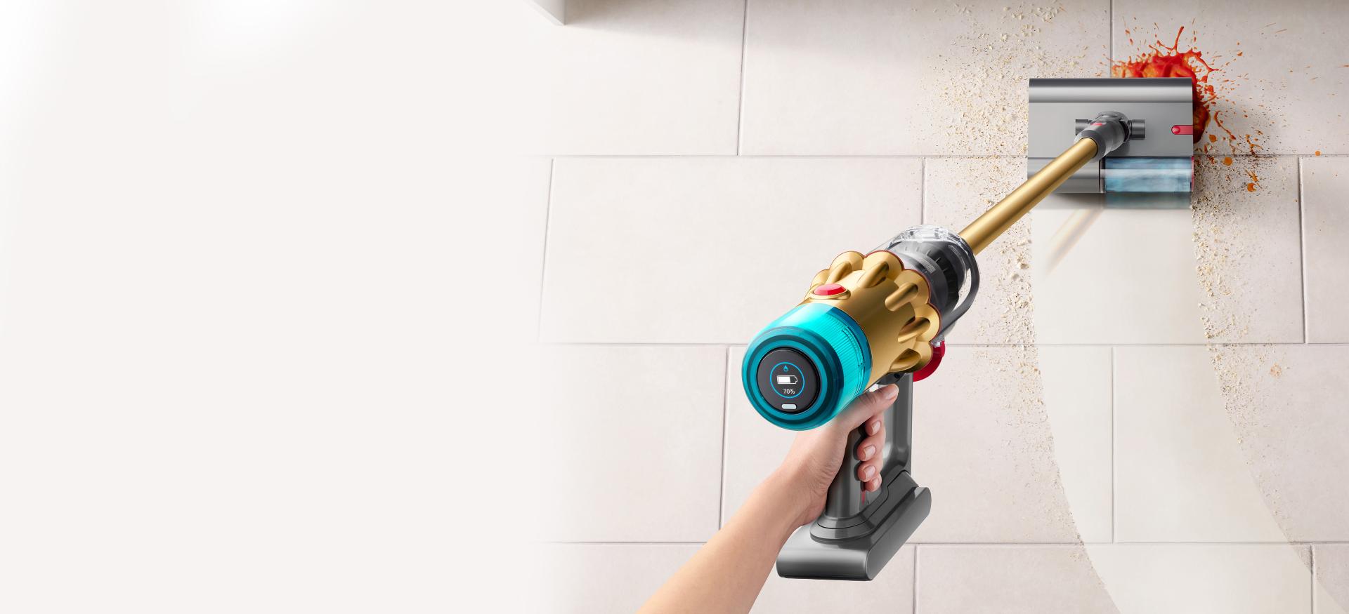 Dyson V12s Detect Slim Submarine wet cleaner head tackling a tough stain on a kitchen floor.