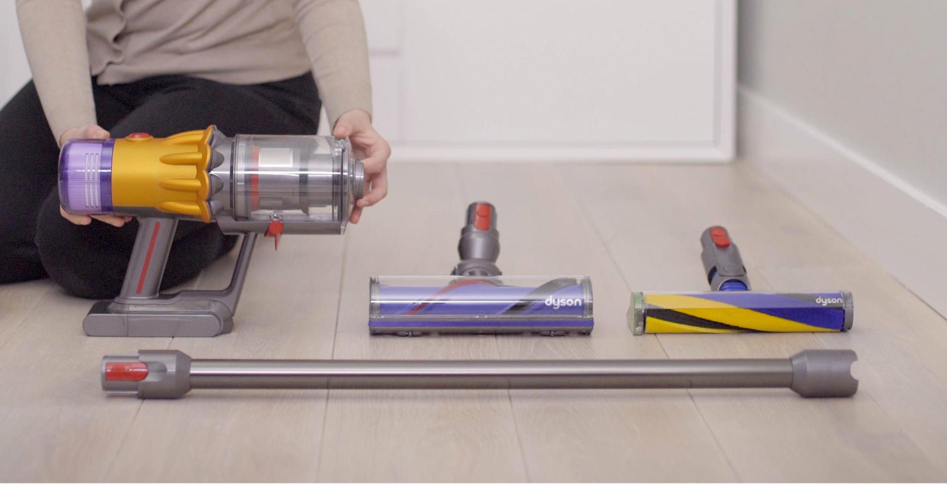 Woman placing Dyson vacuum cleaner on a wall dock.