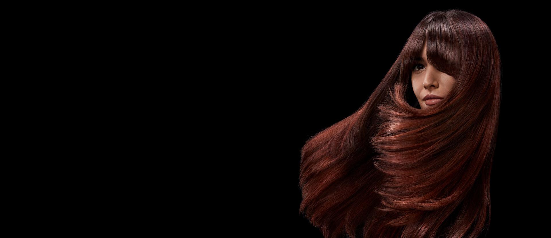 Model with long, shiny, styled hair.