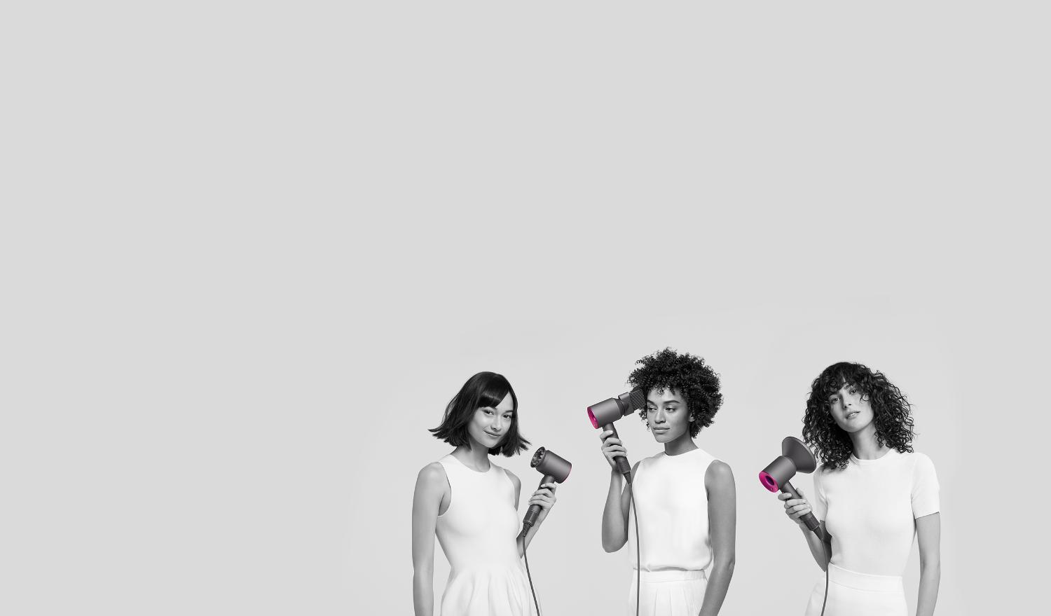 Three women using Dyson Supersonic hair dryers