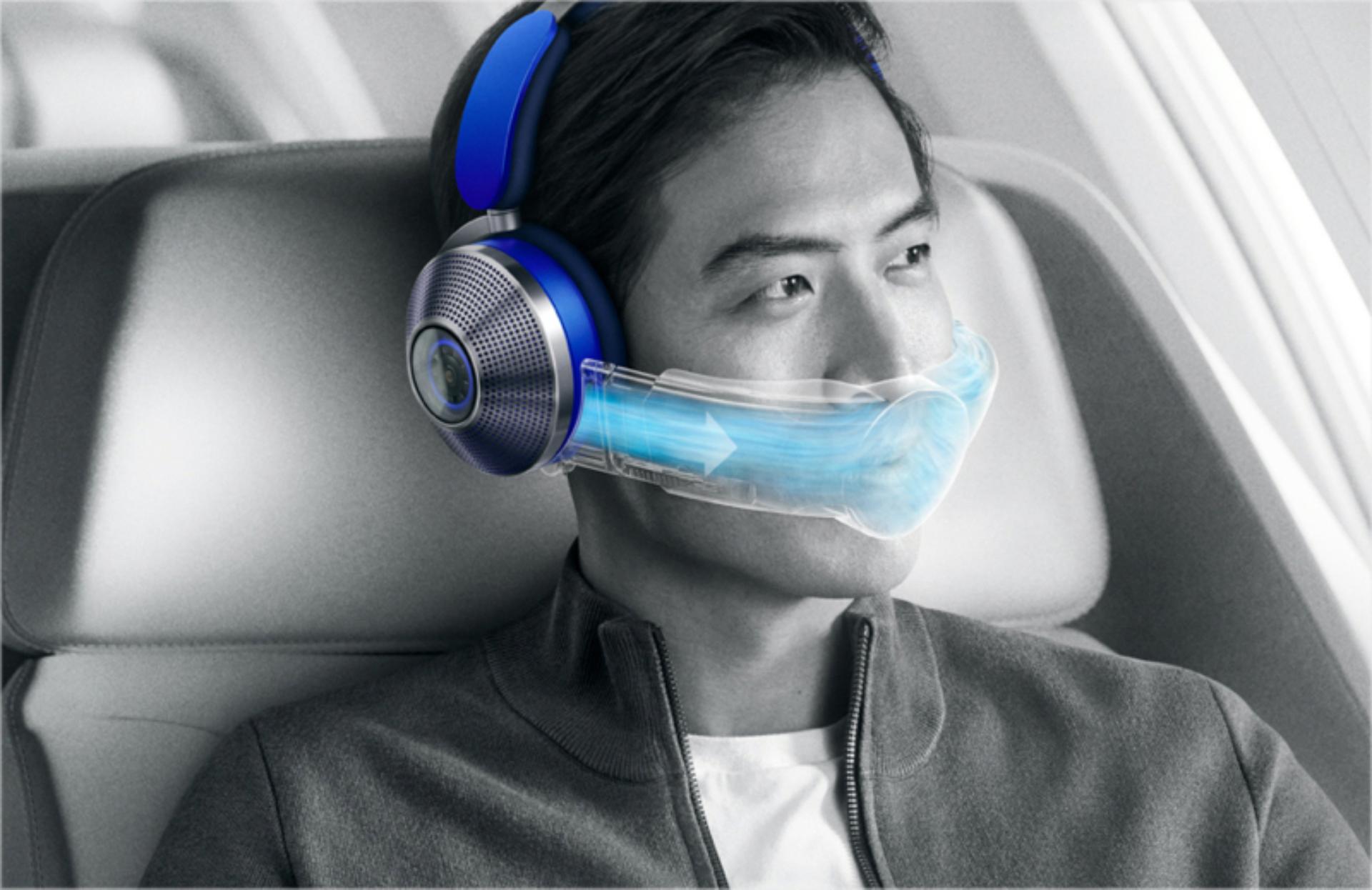 Man wearing the Dyson Zone air-purifying headphones on an aeroplane.