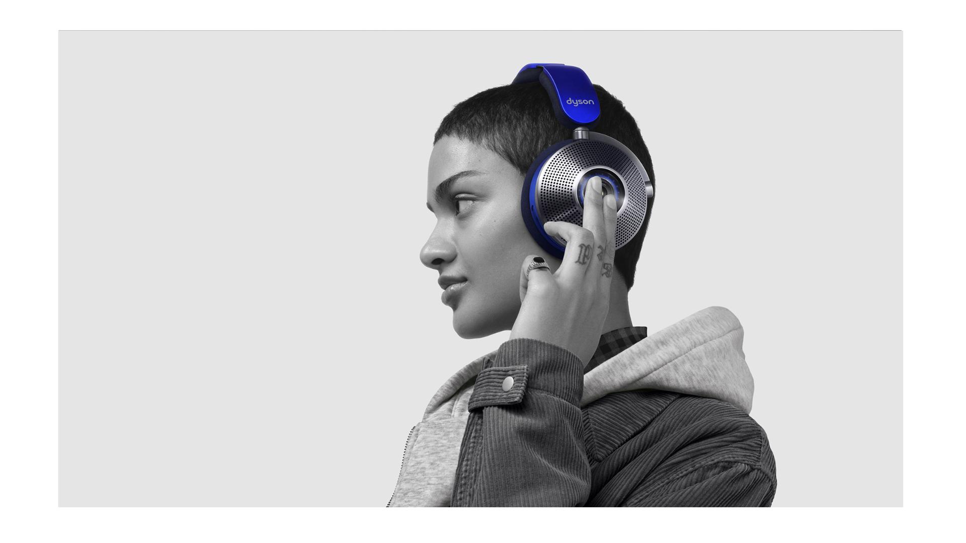 Woman taps the side of the ear cup to change ANC mode.