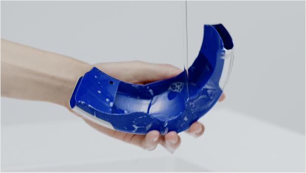 Cleaning the visor under a tap.