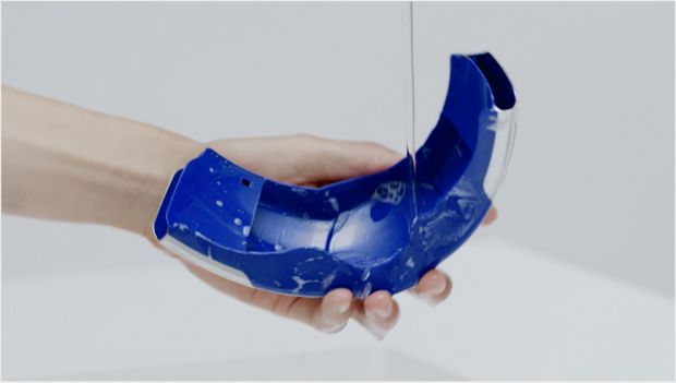 Cleaning the visor under a tap.