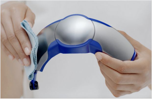 Cleaning the visor with a damp cloth.