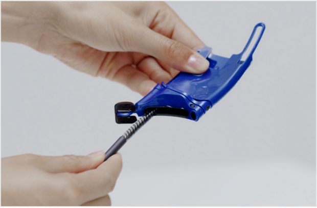 Using the visor brush to clean the visor.