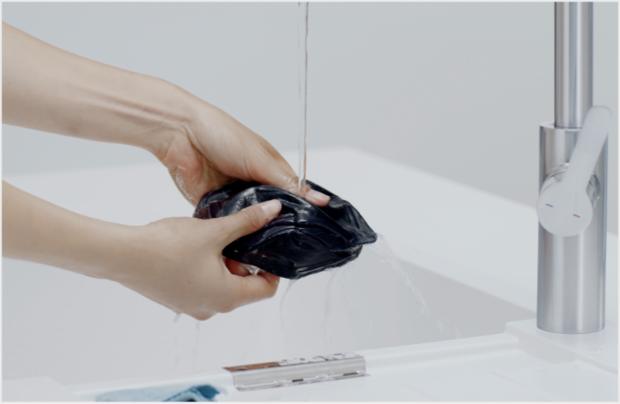 Cleaning the Community face covering with warm, soapy water.