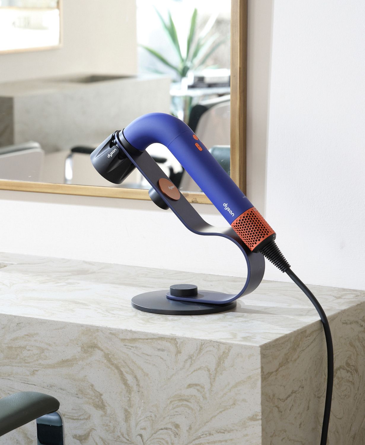 Dyson Supersonic r Professional hair dryer on a stand in a salon.