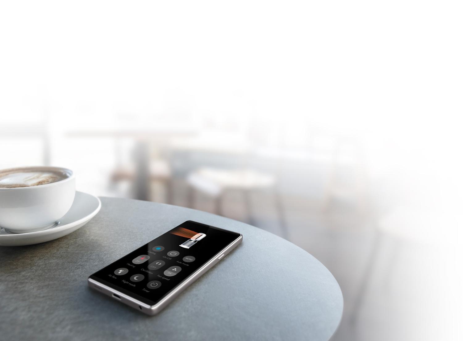 Smartphone op tafel die de Dyson Link-app laat zien