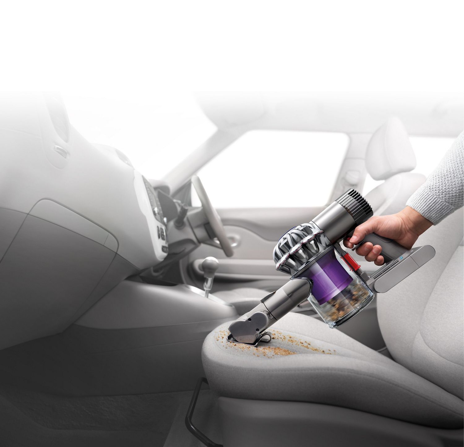  Dyson V6™ handheld vacuum in car interior