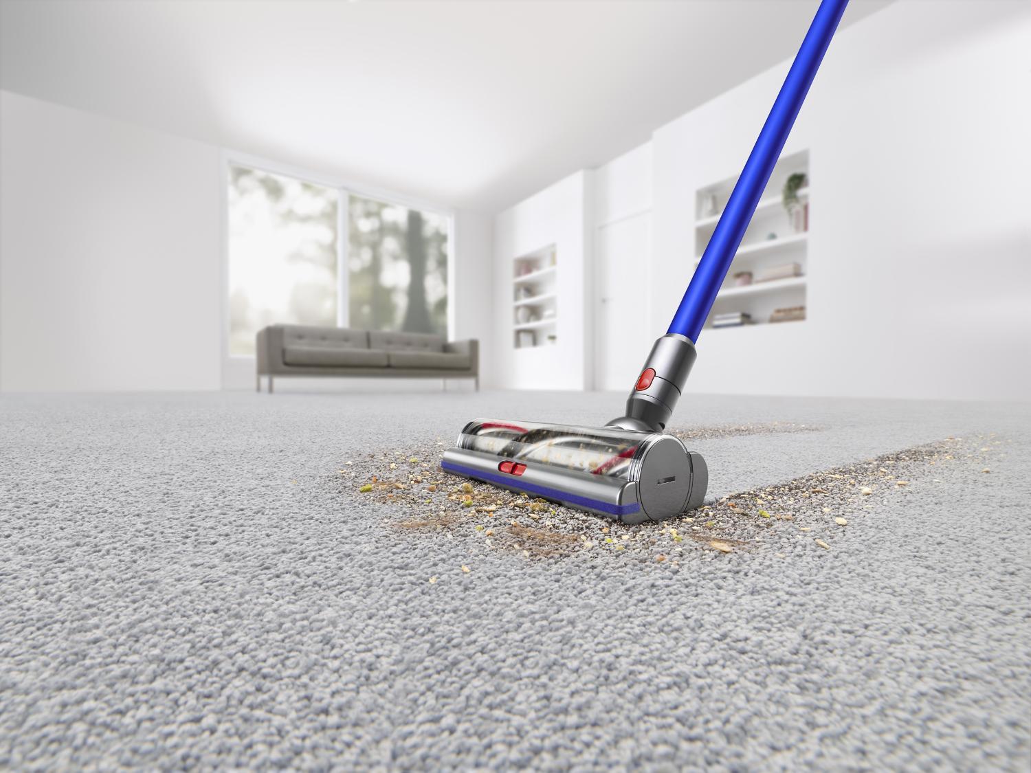 Closeup of vacuum being used on carpet