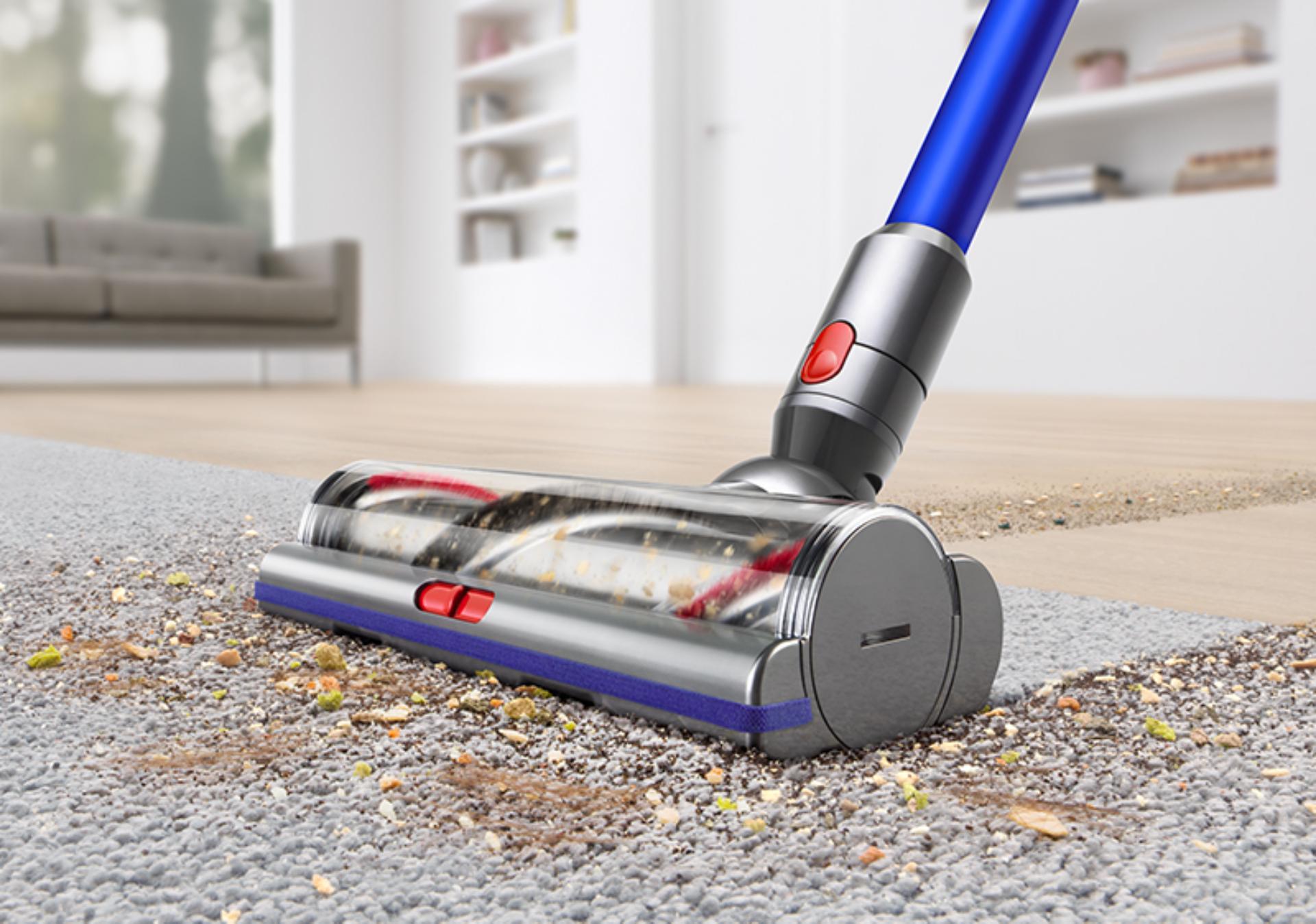 Dyson pet vacuum being used to clean a carpet