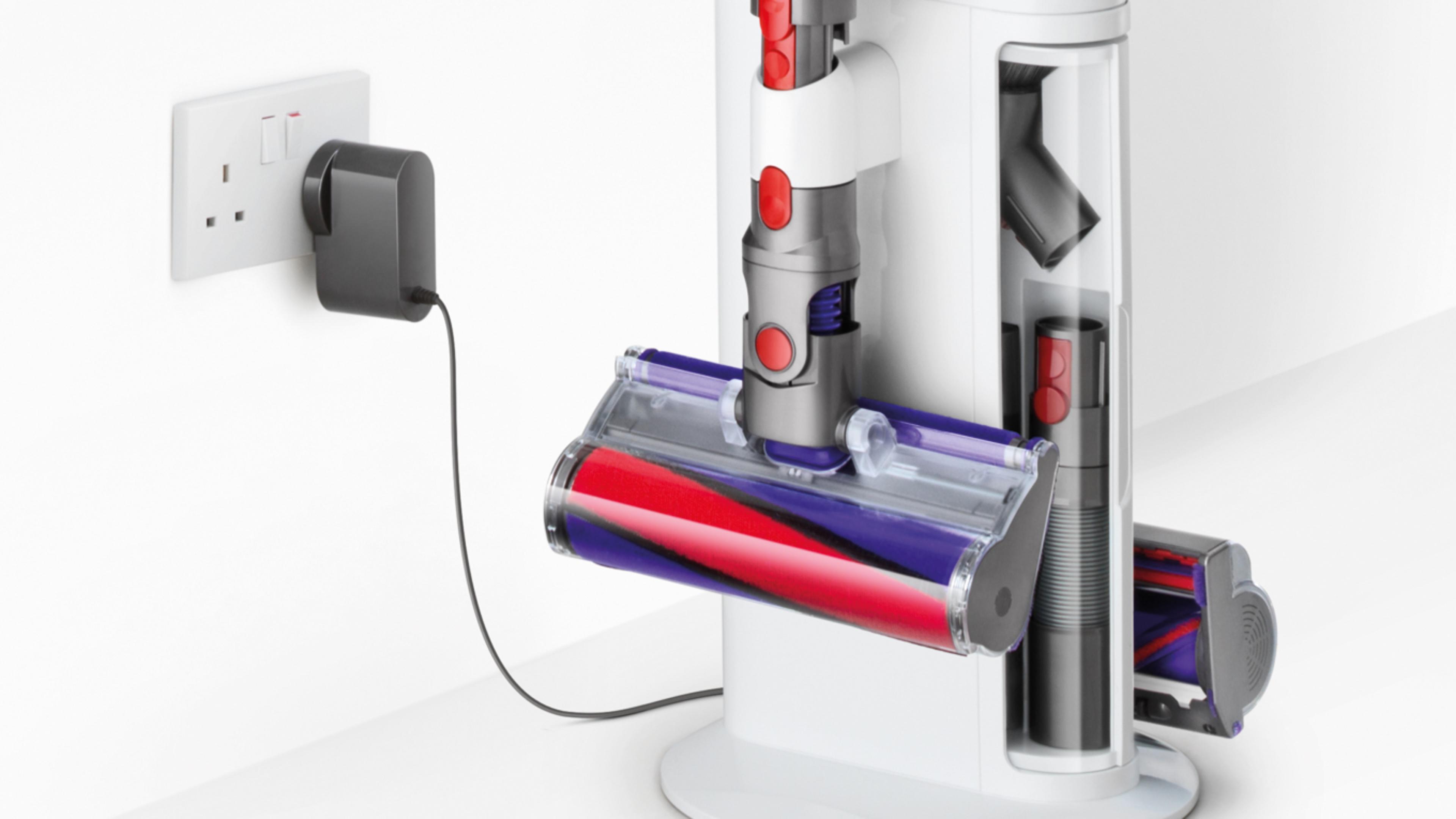 Close-up of Dyson Cyclone V10 Dok™ and wall socket with plug