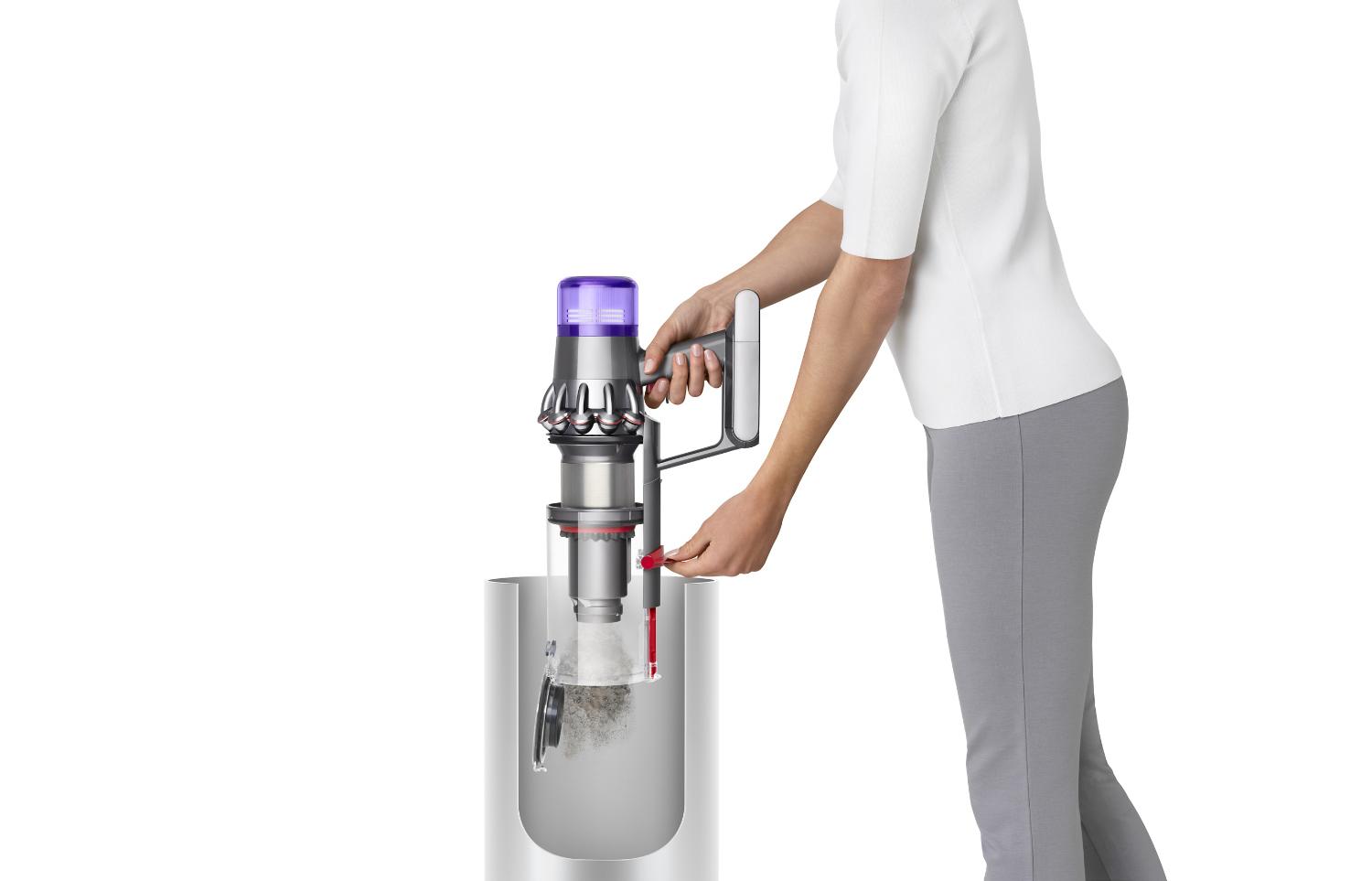 Woman emptying Dyson V11™ vacuum into bin