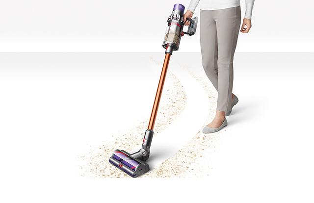 Dyson V10 vacuum cleaner vacuuming debris on flooring