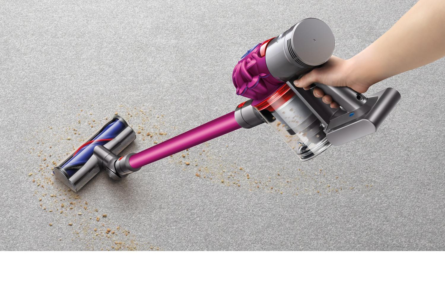 Dyson V7 vacuum cleaner vacuuming debris on carpet
