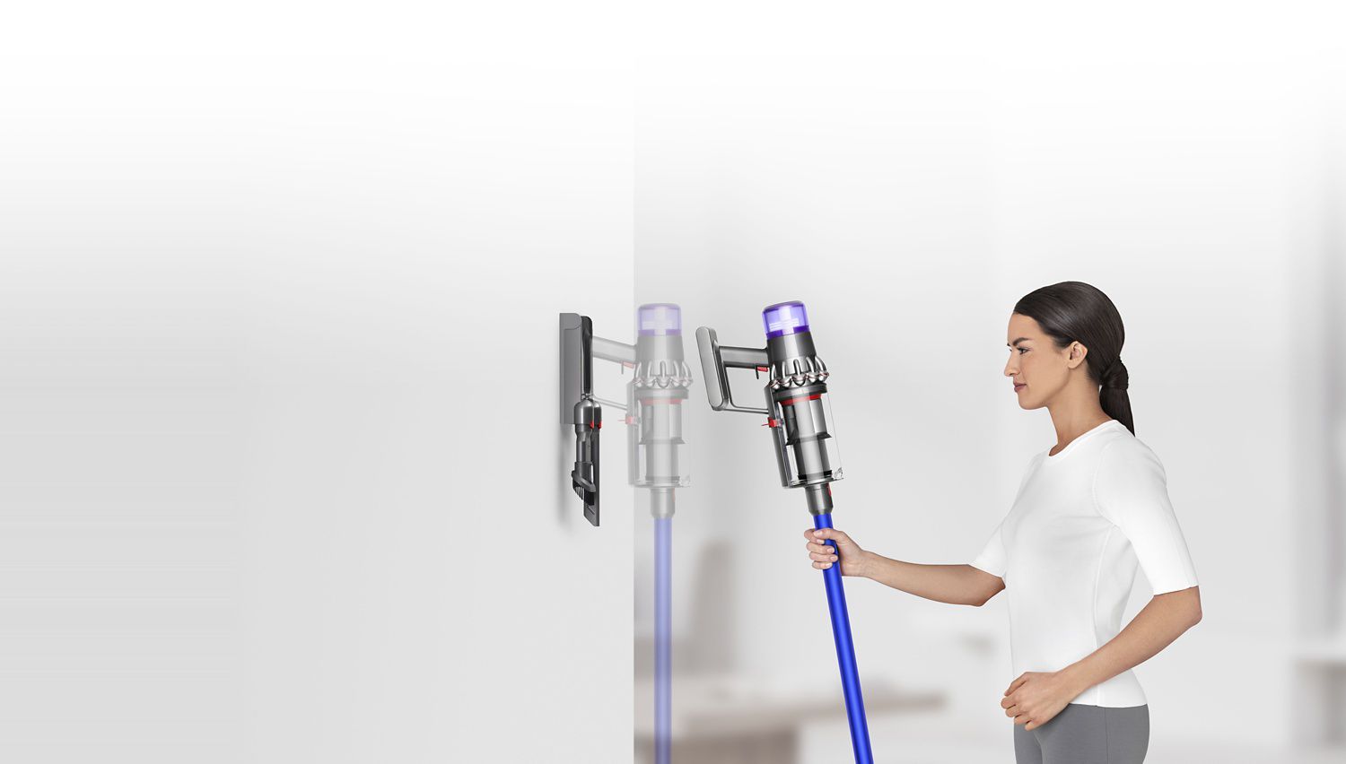Woman placing Dyson V11™ vacuum into wall charging dock