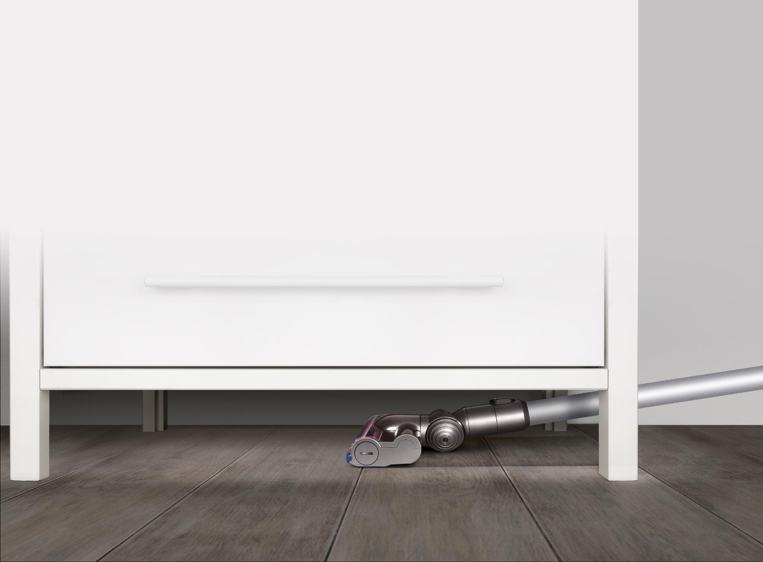 Dyson vacuum beneath furniture