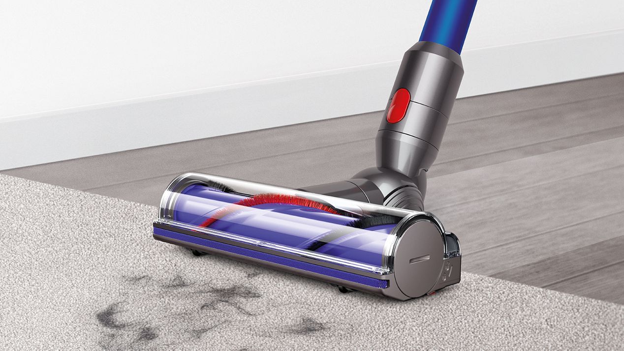 Dyson V7 direct crive cleaner head cleaning across carpet and hard floor Dyson V7 direct crive cleaner head cleaning across carpet and hard floor