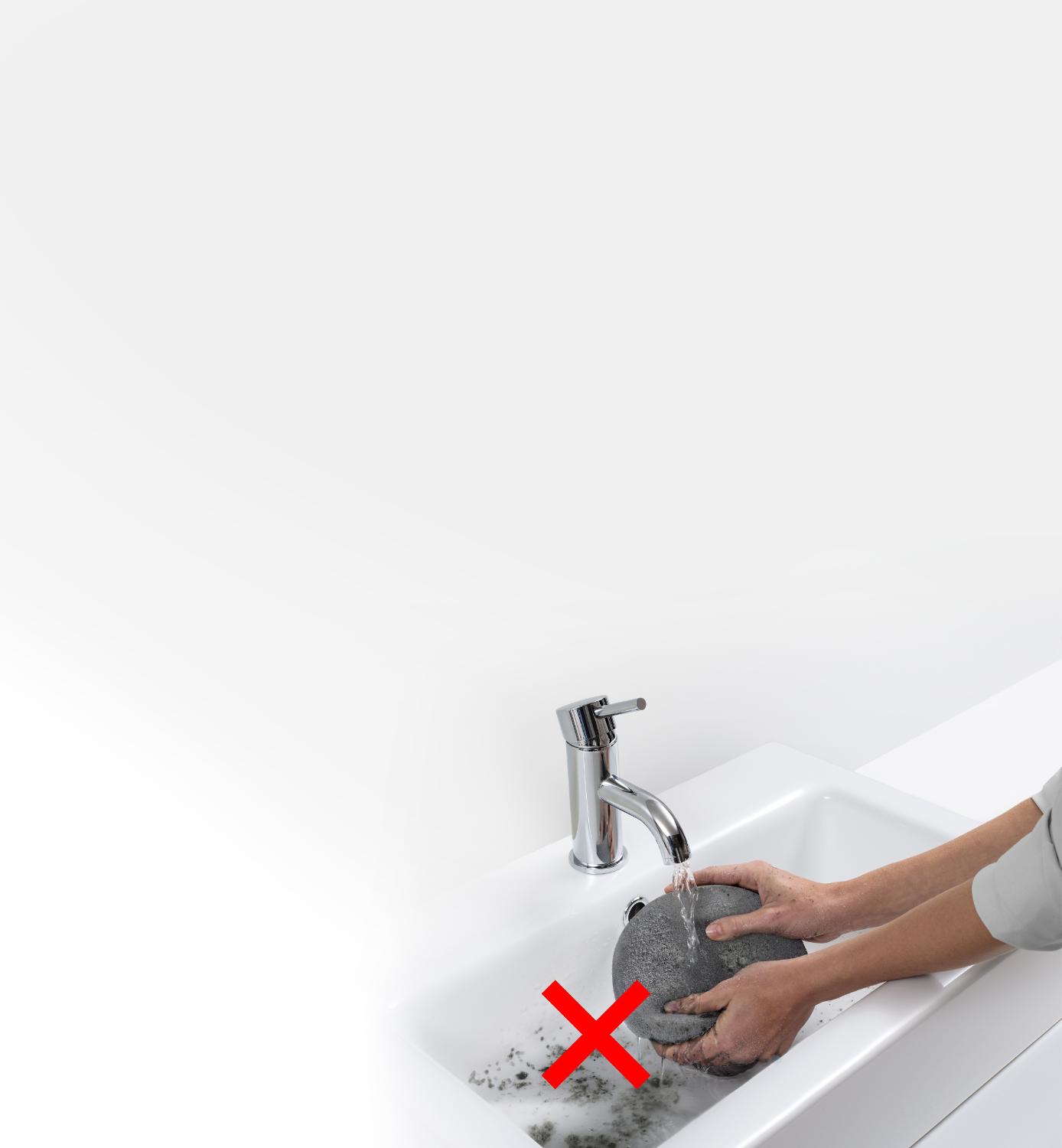 Model washing dirty filter in sink